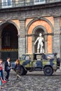 Jeep of of the Italian Army drives by a statue of former King Carlo V