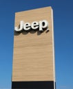 Jeep logo on wood background outside the car dealership of the area. It is the symbol of the american automaker, today a division