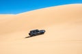 A jeep off road near the coast of Sandwich Harbour in Namibia.