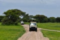 Jeep safari by car on safanna. jeep cruise in the park in africa. adventure tourist rally in wild