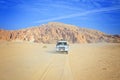 Off-road SUV Toyota Land Cruiser in the desert of Egypt Royalty Free Stock Photo