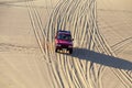 Jeep Safari SUVs on the white dunes of Vietnam, near the city of Mui Ne, entertainment of local people