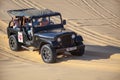 Jeep Safari SUVs on the white dunes of Vietnam, near the city of Mui Ne, entertainment of local people