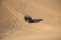 Jeep Safari SUVs on the white dunes of Vietnam, near the city of Mui Ne, entertainment of local people