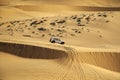 Jeep Safari SUVs on the white dunes of Vietnam, near the city of Mui Ne, entertainment of local people