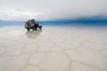 Jeep in the salt lake salar de uyuni, bolivia