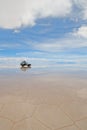 Jeep in the salt lake salar de uyuni, bolivia