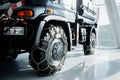 Jeep with snow chains parked indoors at the white tile on vehicle show