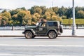 Jeep Wrangler JL at the city street riding on high speed. 2-door SUV Wrangler Sahara on street in motion. Moscow carsharing