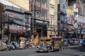 Jeepney taxi drives down the road in downtown Manila
