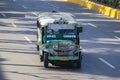 Jeepneys passing on the street in Cebu, Filipino inexpensive bus service. Jeepneys are the most popular means of public transporta