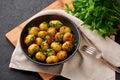 Jeera Aloo in black bowl on dark slate background. Jeera Aloo is indian cuisine dish