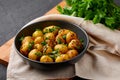 Jeera Aloo in black bowl on dark slate background. Jeera Aloo is indian cuisine dish