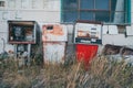 Abandoned gas station pumps next to a closed service station