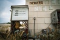 Abandoned gas station pumps next to a closed service station