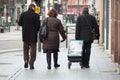 Jehovah witnesses walking in the street with trolley