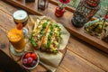 Jeju City,South Korea-July 2019: Two baguette sandwiches and juice drinks on a wooden table with vintage oil lamp decorations Royalty Free Stock Photo