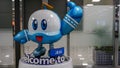 A robot figurine on a pedestal with the inscription `Welcome to Jeju` in blue and white at