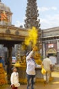 JEJURI, PUNE DISTRICT, MAHARASHTRA, August 2018, Devotee throwing turmeric powder at Lord Khandoba temple