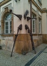 Stilt walker statue in building walls