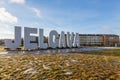 Jelgava city name sign, ice, frost, sun and blue sky