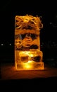 Jelgava / Latvia - February 10th, 2017: Small carved ice sculpture of an old man with a pipe at night of International Ice Sculpt