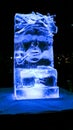 Jelgava / Latvia - February 10th, 2017: Small carved ice sculpture of an old man with a pipe at night of International Ice