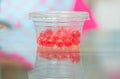 Jelly ball round in plastic container on table blur background