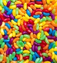Jelly beans candies colourful rainbow wallpaper. Festive party background made of glucose sweets for confectionary store