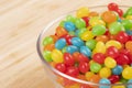 Jelly Beans candy in glass bowl isolated on wooden background Royalty Free Stock Photo