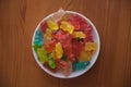 Jelly candy bears on wooden background. Candy bears on a bowl. Heap of jelly candy bears.