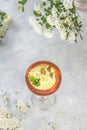 Jelly dessert. Delicious fruit dessert with curd cream in elegant stemware glass on gray table surface Royalty Free Stock Photo