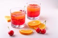 Jelly dessert with strawberries in drink glass with cherry berries and orange slices nearby Royalty Free Stock Photo