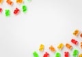 Jelly gummy bears candy background. Fruit gum candies frame theme. Red, orange, yellow and green bears.