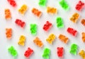 Jelly gummy bears laying flat candy background. Fruit gum candies theme. Red, orange, yellow and green. Royalty Free Stock Photo