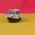 Jelly in on pot isolated on colored background. Fresh colors pastel trend