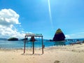 Jember, Indonesia - January 2023 : Papuma blue sea from the beach with sign cloudy blue sky