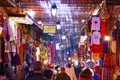 JEMMA DAR FNA, THE MAIN BAZAAR, MARRAKECH, MOROCCO, NOVEMBER 10, 2018. People walking on a corridor surrounded by booths Royalty Free Stock Photo