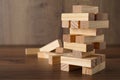 Jenga tower and wooden blocks on table, space for text
