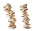 Jenga towers of wooden blocks falling on white background