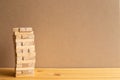 Jenga wood block tower with brown background Royalty Free Stock Photo