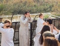 Priest arrived at the Epiphany Rite use Holy Water for ablution from the Jordan River on the Baptismal Site of Jesus Christ near Royalty Free Stock Photo
