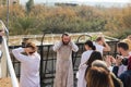 Priest arrived at the Epiphany Rite use Holy Water for ablution from the Jordan River on the Baptismal Site of Jesus Christ near Royalty Free Stock Photo