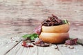 Jerked meat, cow, deer, wild beast or biltong in wooden bowls on a rustic table, selective focus