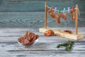 Jerky meat with rosemary on a rope with clothespins