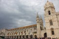 Jeronimos monastery with crowd of visitors. Tourists near ancient abbey in Lisbon. Facade of monastery of St Jerome.