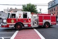 Jersey City, USA - June 30, 2023: firetruck truck Fire Department turning at the street, side view