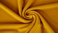 Jersey knit fabric detail and closeup in beautiful golden mustard color