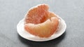 Jeruk Bali, Balinese Pomelo Grapefruit on White Plate, Isolated on Grey Table