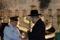 Chief Rabbi of Israel Rabbi David Lau lighting Hanukkah candles at the Western Wall next to Police Chief Roni Alshikh